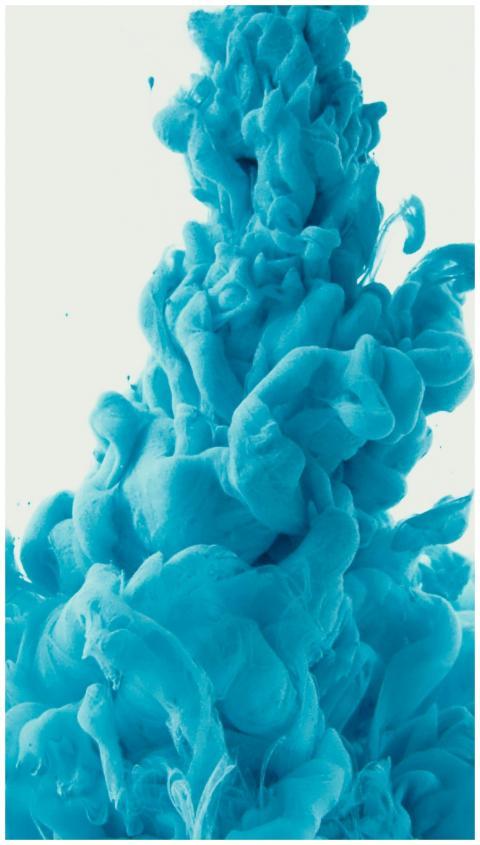 Abstract close-up of vibrant blue ink swirling und