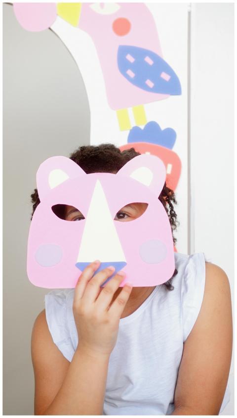 A young child enjoys creativity with a colorful ha