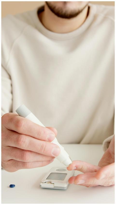 An adult using a blood glucose meter on a white su