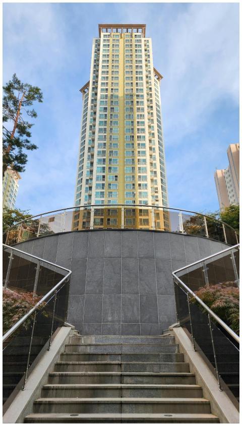 Upward view of a tall modern building with stairs