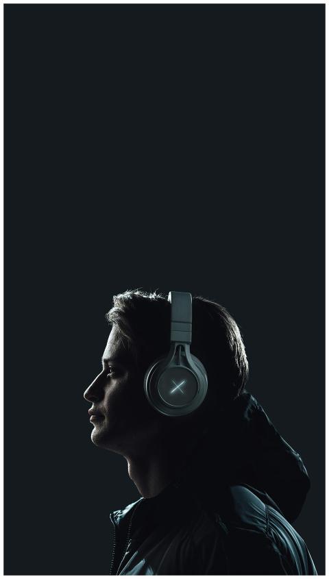 Moody portrait of a young man wearing headphones a