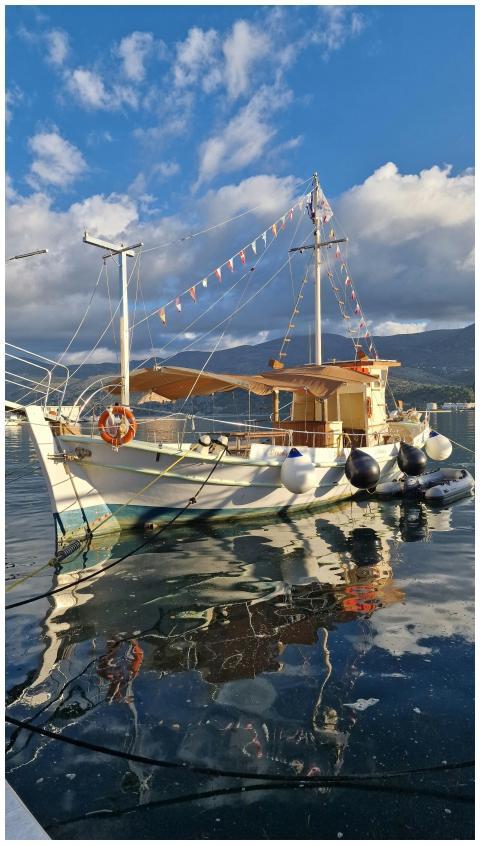 A classic wooden boat with reflections in a serene