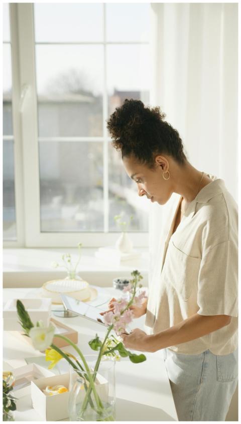 A young woman enjoys a peaceful moment arranging f