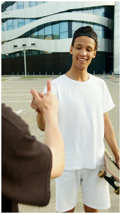 Casual outdoor moment of a young man with a skateb