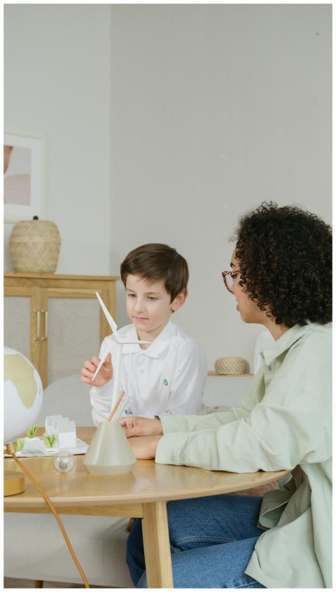 A young boy learns about wind energy with a teache