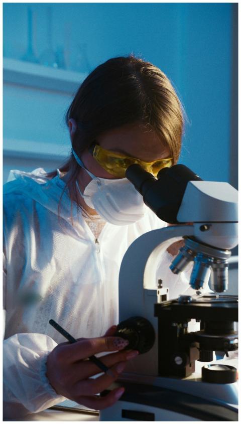 A female scientist examines a sample using a micro