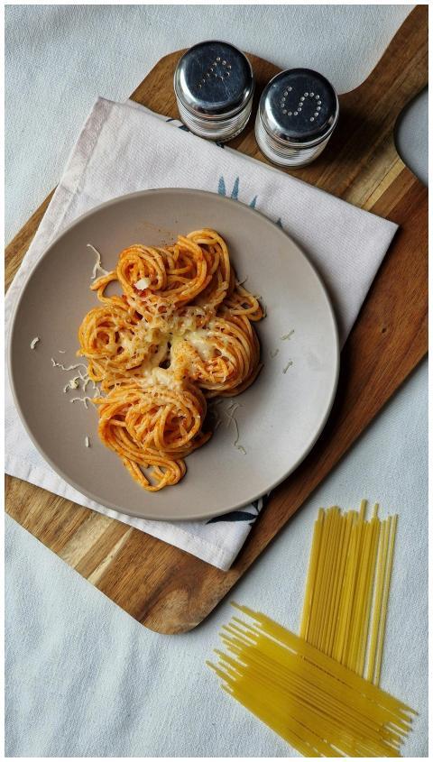 Tasty spaghetti served with tomato sauce and chees