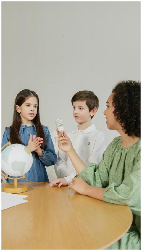 Teacher explains renewable energy concepts to chil