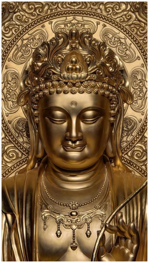 Close-up of a golden Guanyin statue showcasing int