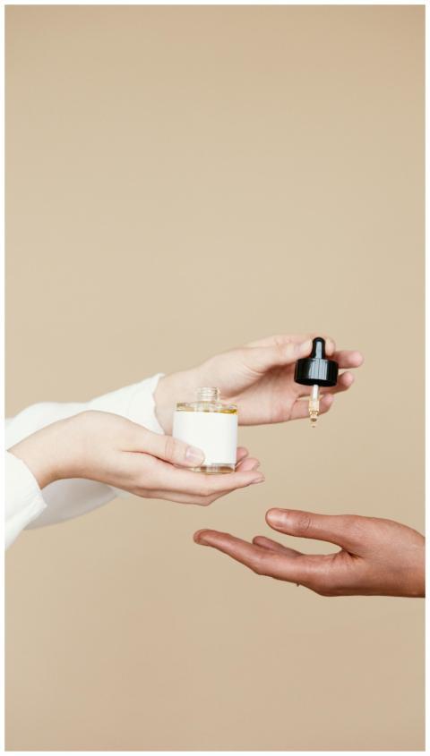 Minimalist photo of hands with a skincare dropper
