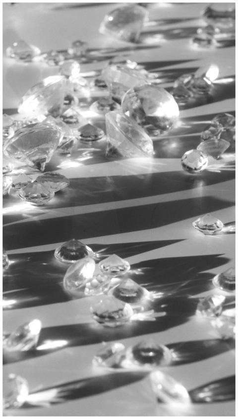 A collection of shining gemstones on a striped mon