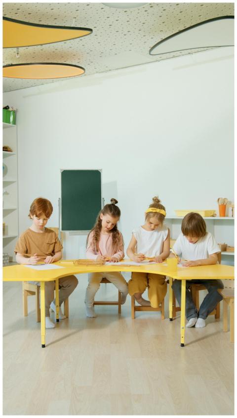 Children learning together at a table in a bright