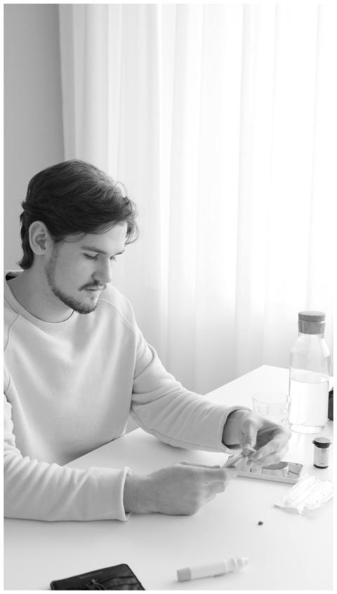 A young adult checking blood glucose levels using
