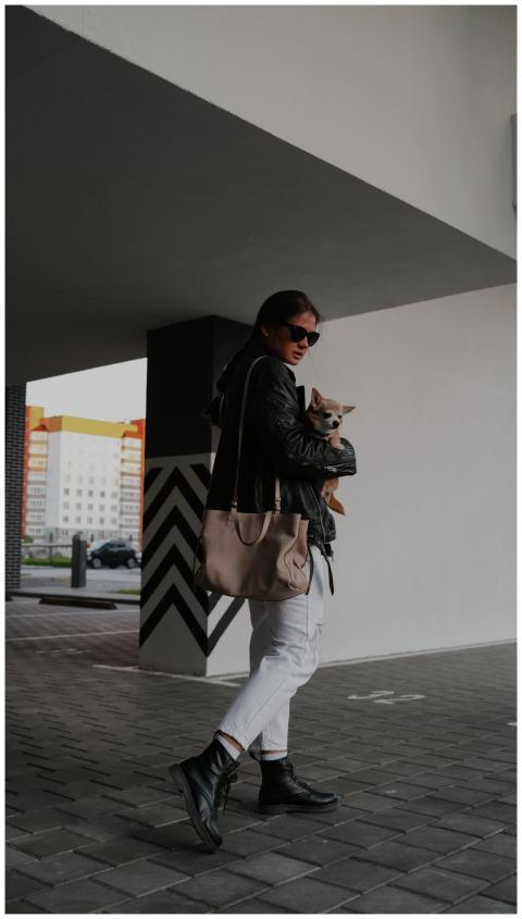 Woman in stylish attire walks confidently with a p