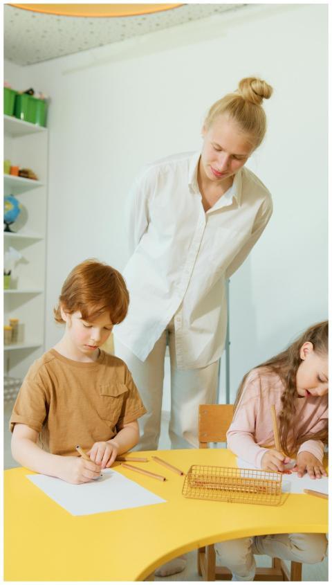 Children focus on schoolwork as a teacher oversees