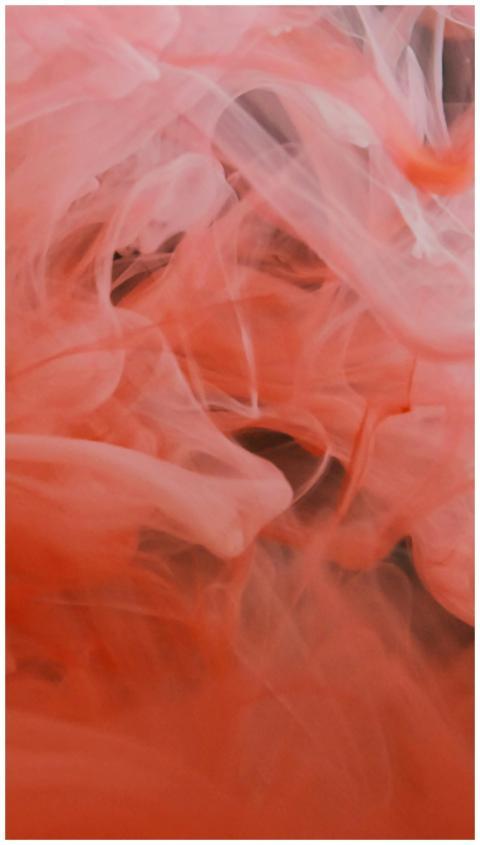 Vivid and dynamic swirls of red smoke captured in