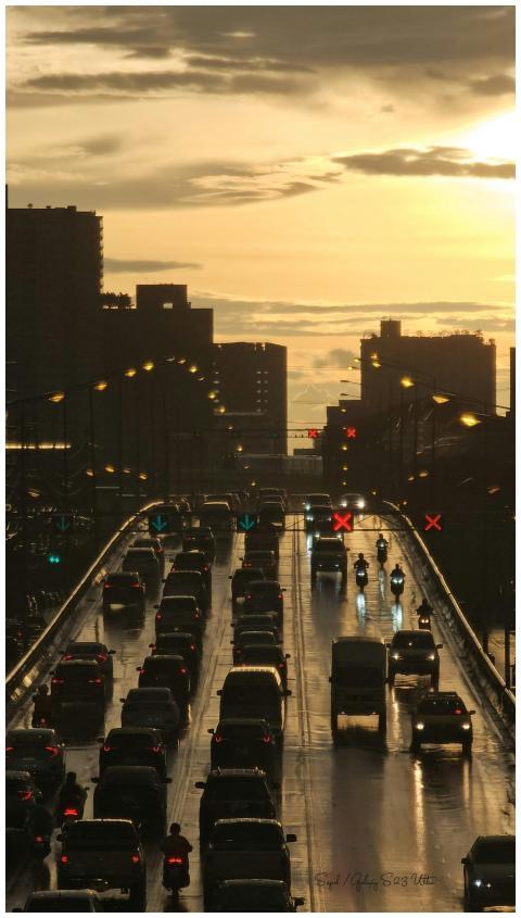 Silhouetted skyline and traffic on a rainy express