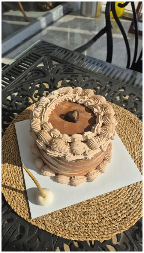 Rich chocolate cake with intricate frosting on out