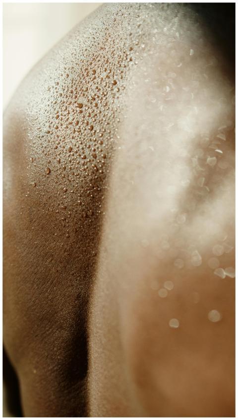 Detailed close-up showing sweat droplets on human