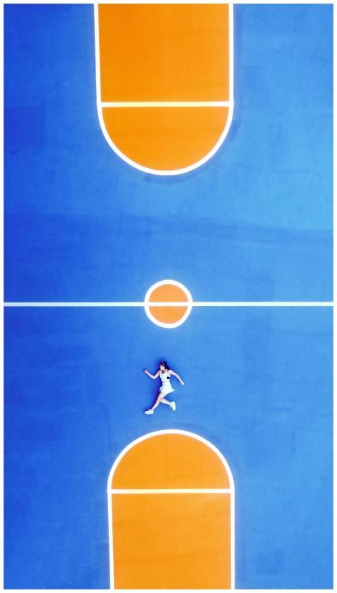 Top-down shot of a woman lying on a colorful outdo