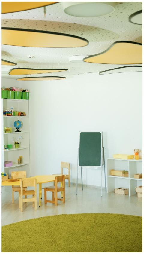 Bright, empty classroom with wooden furniture and