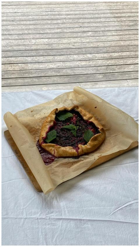 Close-up of a homemade rustic berry galette on par