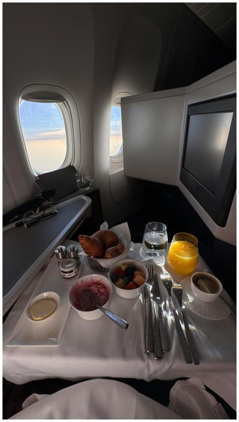 Luxurious first class breakfast setup with croissa
