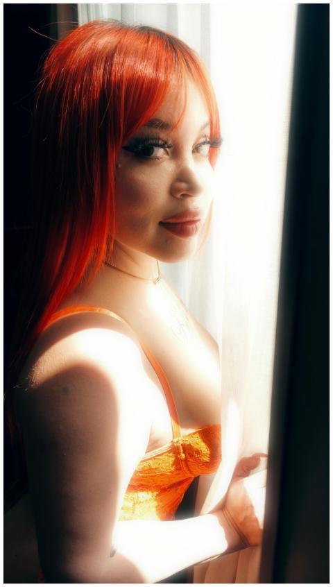 A vibrant portrait of a woman with red hair lookin