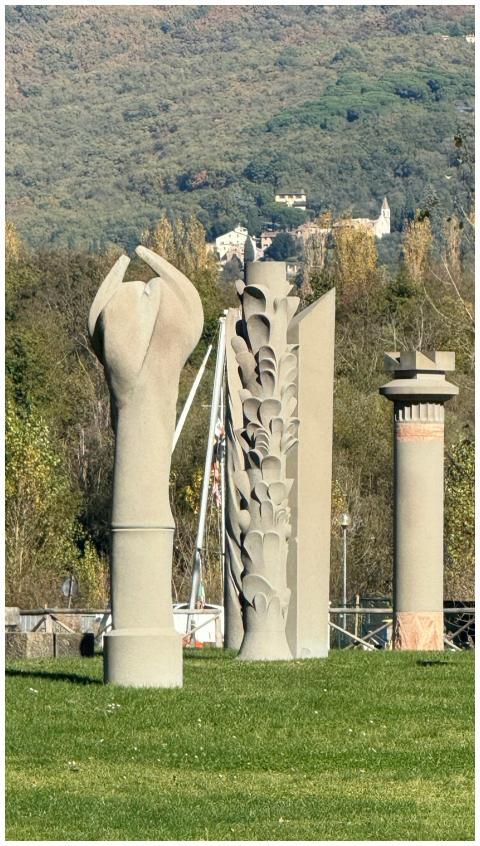 Abstract sculptures set against a hilly backdrop i