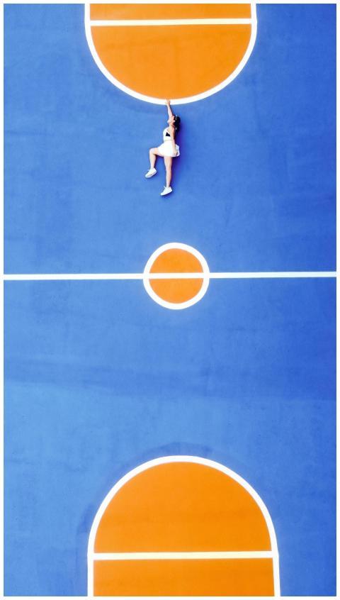 Top view of sportswoman resting on bright ground f