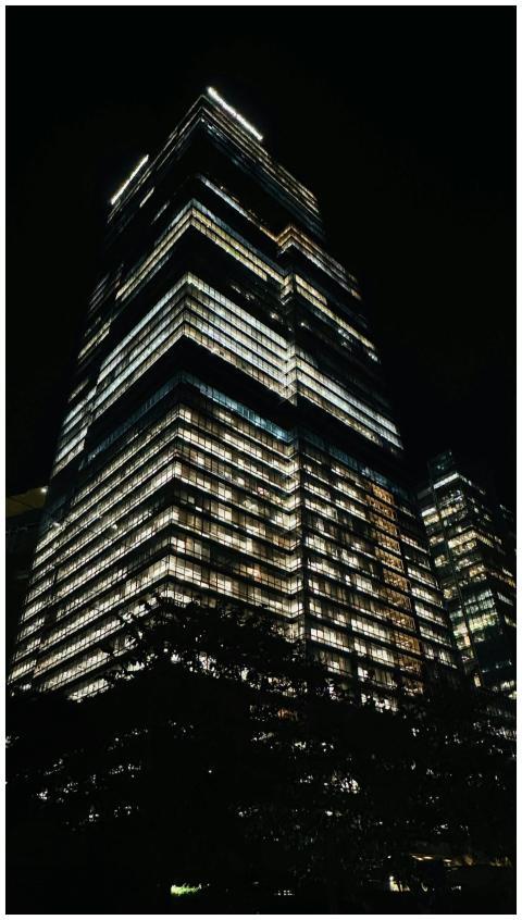 Illuminated Skyscraper Against Night