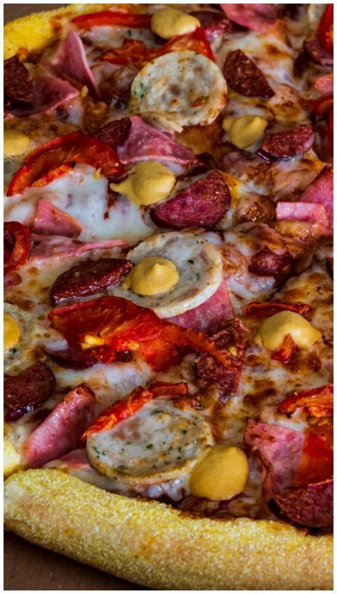 Mouth-watering close-up of a loaded sausage and pe