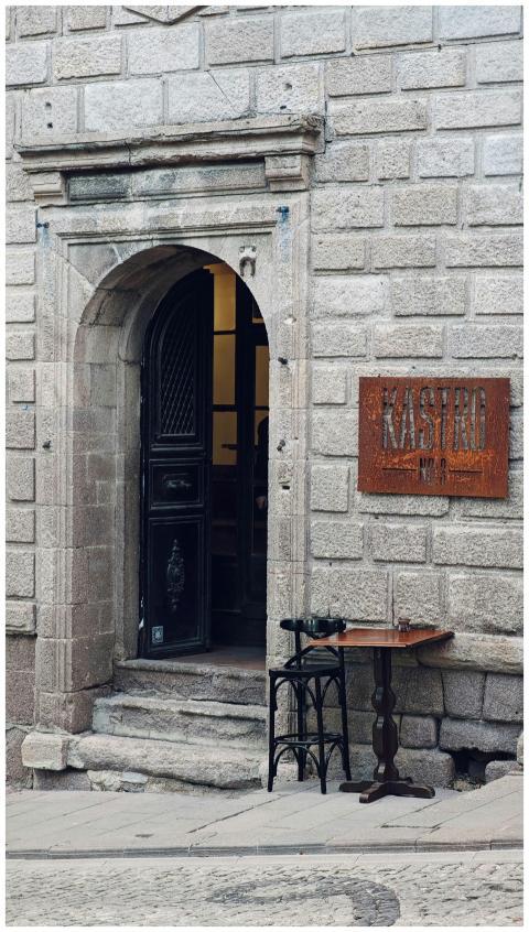 A vintage stone entrance with an open door leading