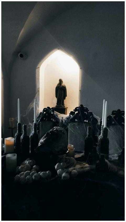 Dimly lit gothic altar adorned with candles and re