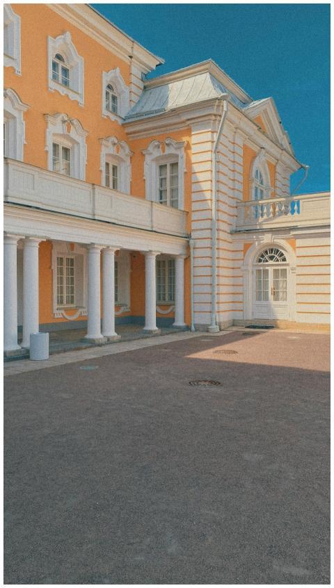 Yellow neoclassical building with columns on a sun