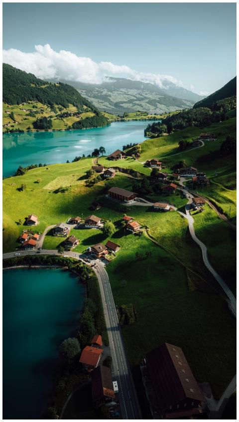 Breathtaking aerial shot of Lungern Lake and villa