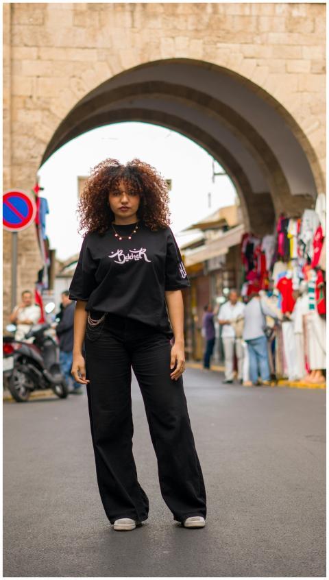 A stylish young woman posing confidently in a vibr