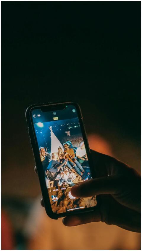 Group of friends enjoying a night beach party, cap