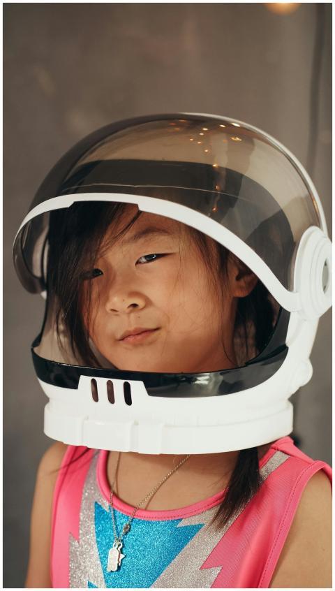 Adorable Asian girl smiling while wearing an astro