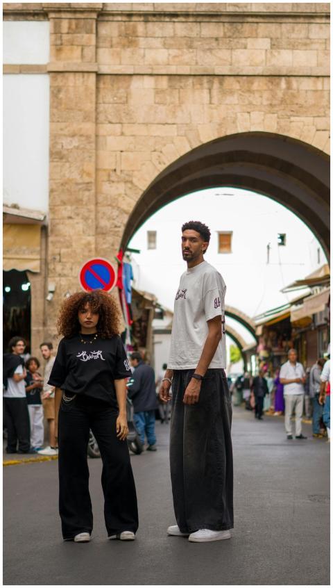 A stylish couple poses in a Moroccan street, showc