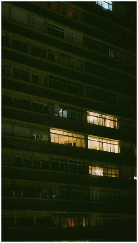 A towering apartment building in São Paulo lit up