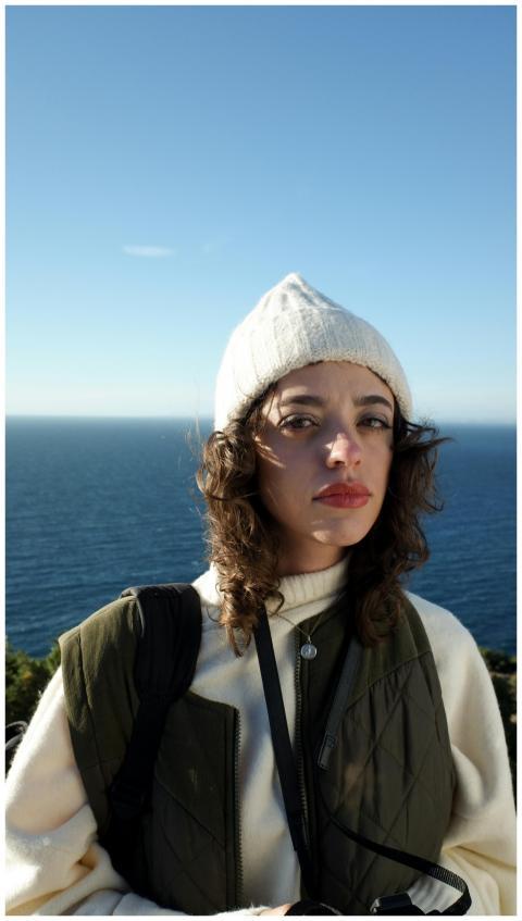 Portrait of a young woman wearing a beanie and swe