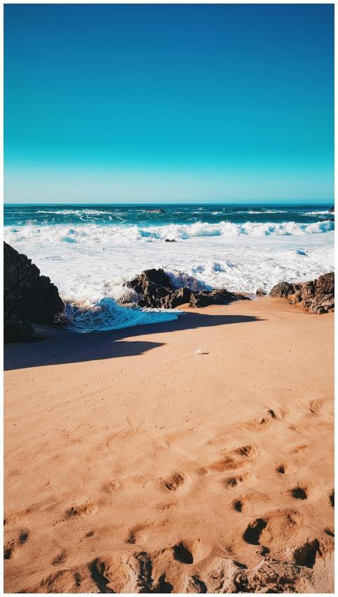 Golden sands and vibrant ocean waves at Colares be