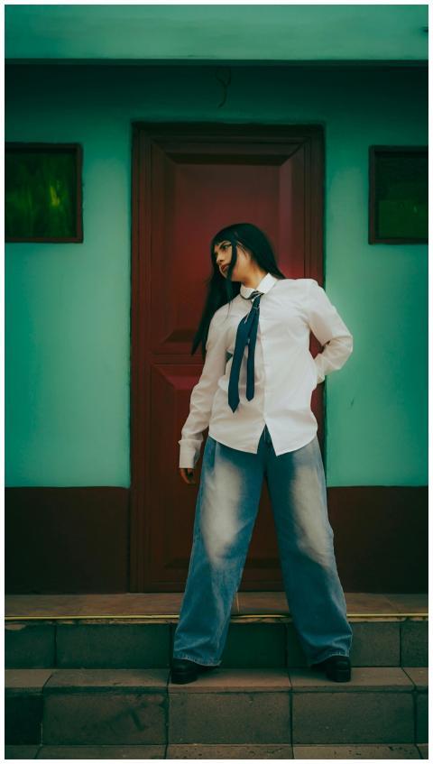 A fashionable woman poses in a trendy outfit again