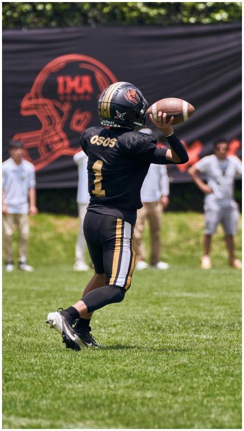 A young quarterback throws a football during a sun