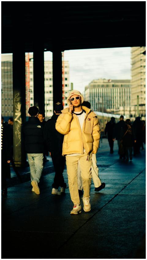 Young adult in stylish attire walking in urban are