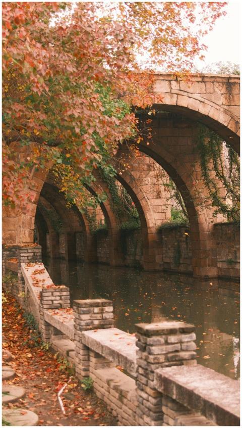 A tranquil scene of an ancient stone bridge spanni