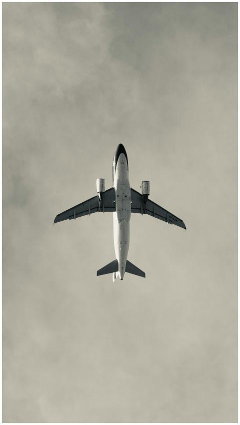 Aerial view of an airplane flying through a cloudy