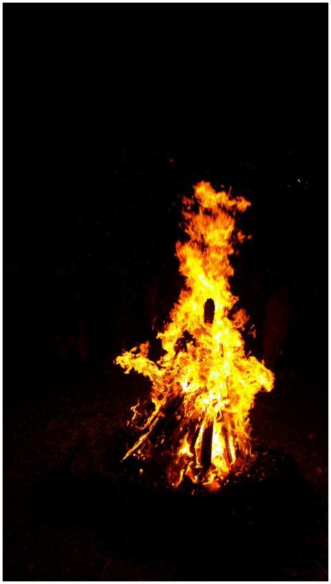 Bright campfire burning strongly, casting warm lig