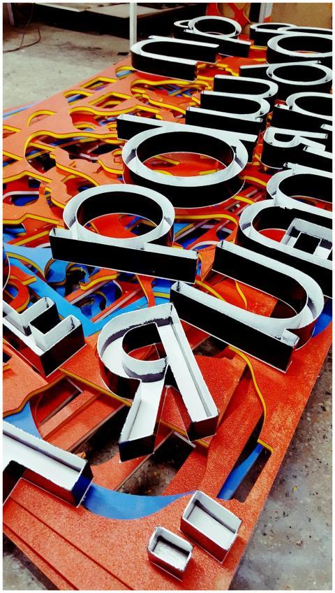 Vibrant neon letters arranged artistically, showca